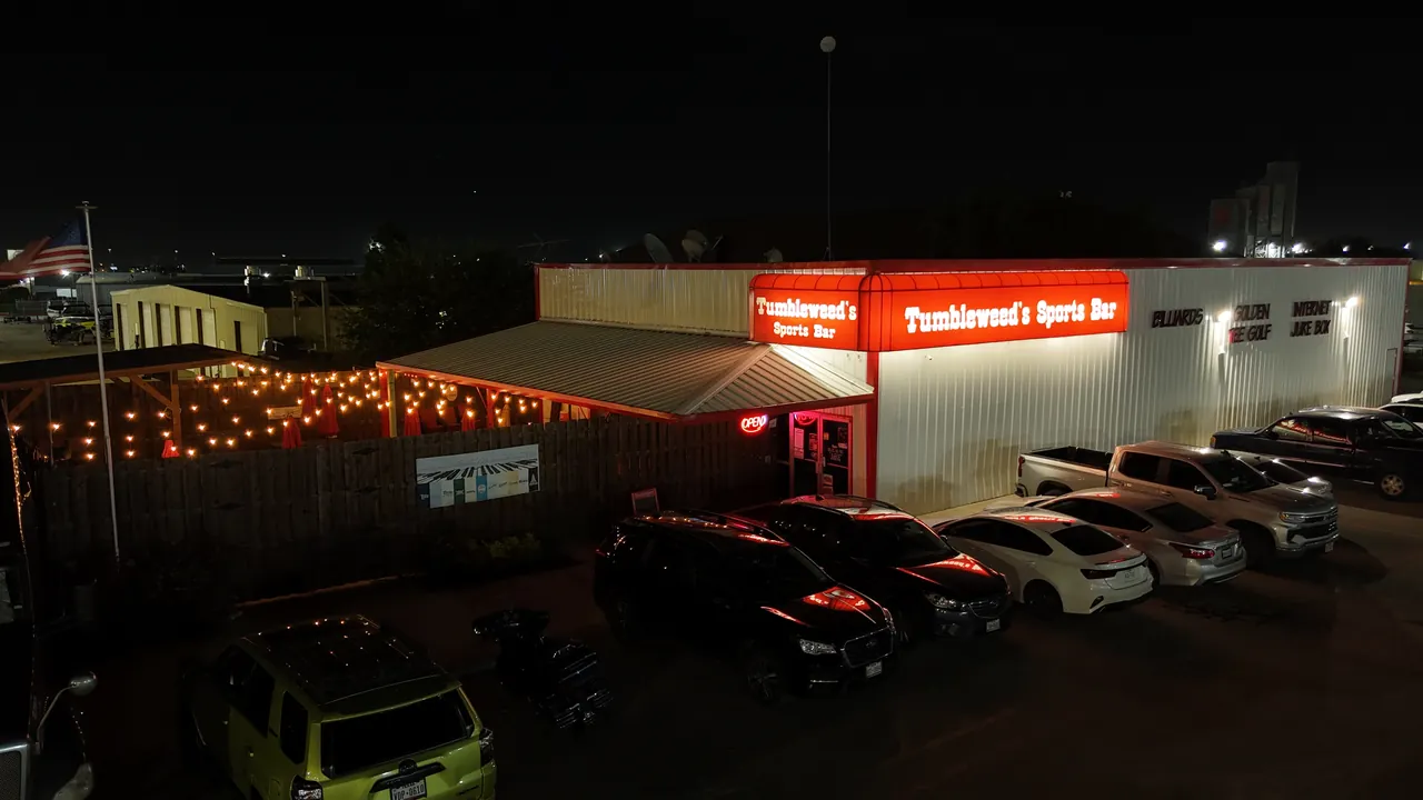Tumbleweeds Sports Bar entrance and illuminated red sign on NE Loop 820