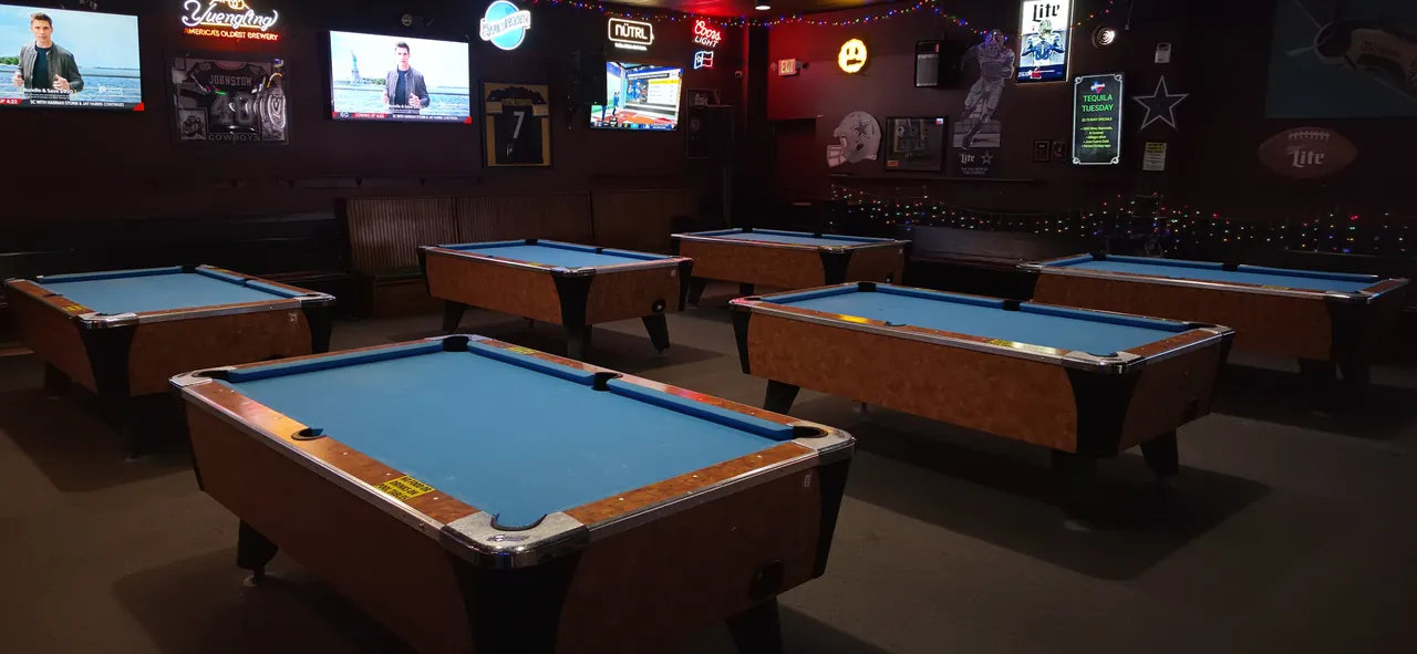 Blue-felt pool tables and sports TVs at Tumbleweeds Sports Bar in Fort Worth